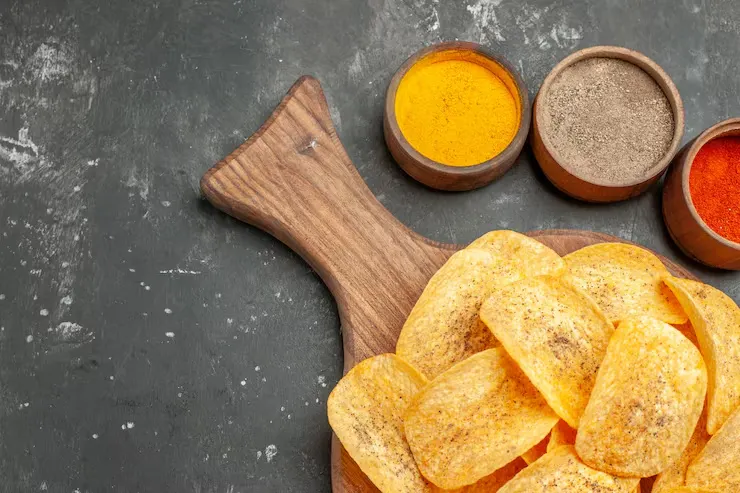 half-shot-tasty-potato-chips-spices-with-ketchup-gray-table