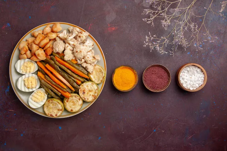 top-view-cooked-vegetables-with-egg-meal-seasonings-dark-space