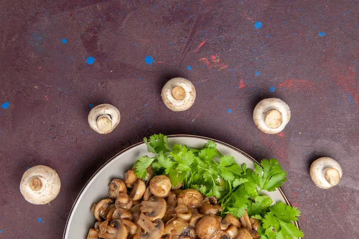 top-view-yummy-cooked-mushrooms-with-greens-dark